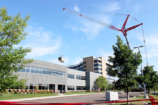 A Wilkerson Crane lifts the old air handling unit from Garmin Building 1 preparing to install a new unit