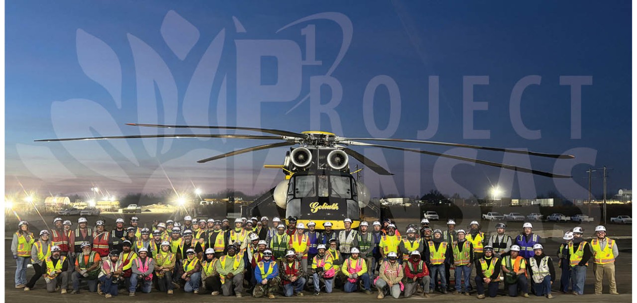large group of P1 Construction workers in front of a helicopter