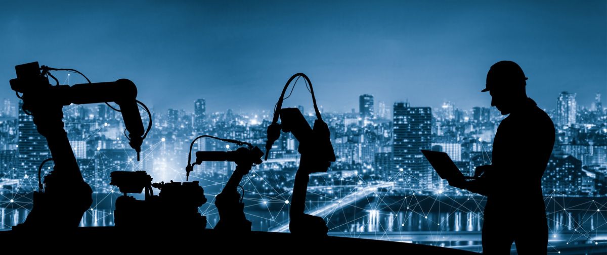 technician programming industrial controls with city background